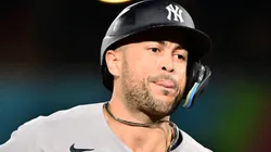 Giancarlo Stanton #27 of the New York Yankees runs the bases after hitting a home run.