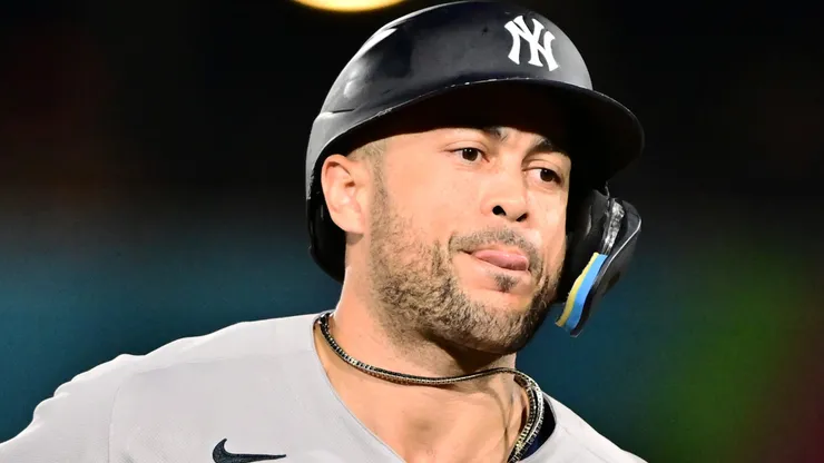 Giancarlo Stanton #27 of the New York Yankees runs the bases after hitting a home run.