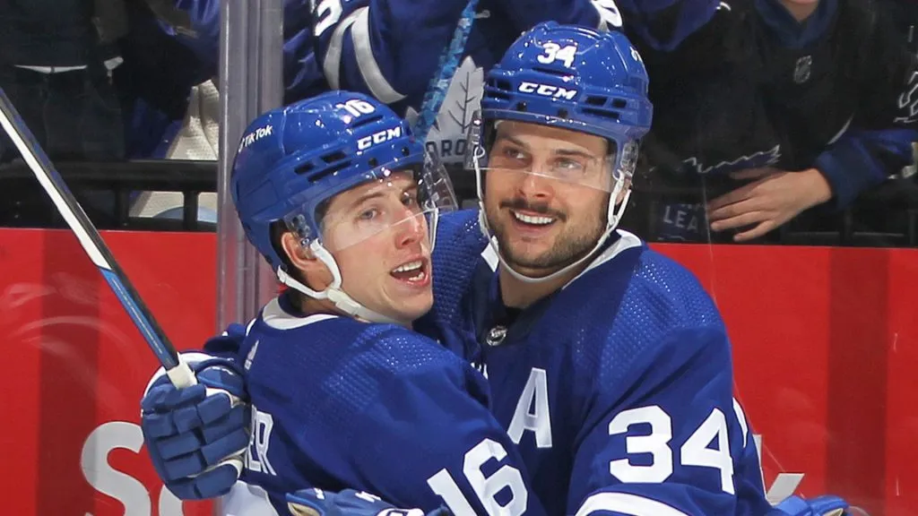 Mitchell Marner and Auston Matthews celebrate a Maple Leafs goal.