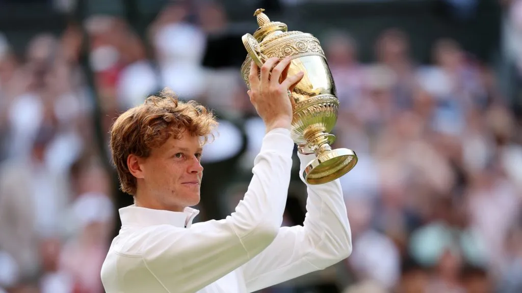 Jannik Sinner raises the Wimbledon trophy after defeating Carlos Alcaraz. (Clive Brunskill/Getty Images)