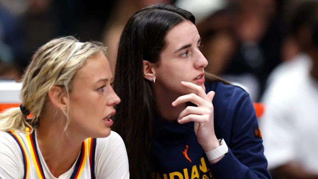 Sophie Cunningham and Caitlin Clark watch from the bench against the Dallas Wings&nbsp;(Ron Jenkins/Getty Images)