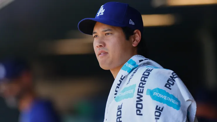 Shohei Ohtani #17 of the Los Angeles Dodgers looks on from the dugout.