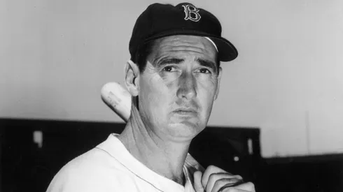 Baseball legend Ted Williams (1918 – 2002) of the Boston Red Sox holds a baseball bat at Shriner's Day in Fenway Park August 22, 1958.