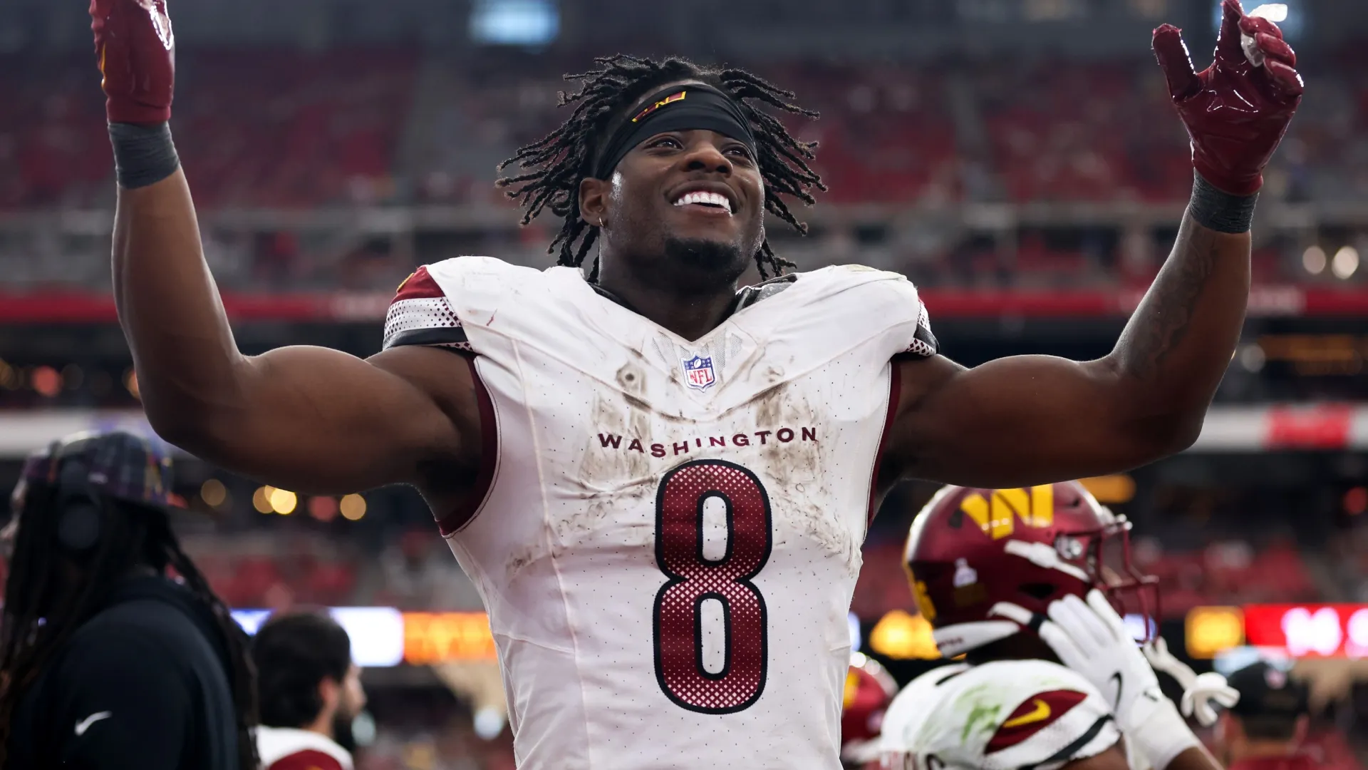 Brian Robinson Jr. #8 of the Washington Commanders celebrates after a touchdown