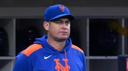 New York Mets manager Carlos Mendoza looks on.