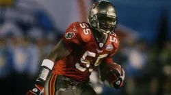 Derrick Brooks #55 of the Tampa Bay Buccaneers picks up a fumble by Oakland Raiders quarterback Rich Gannon in 2003.