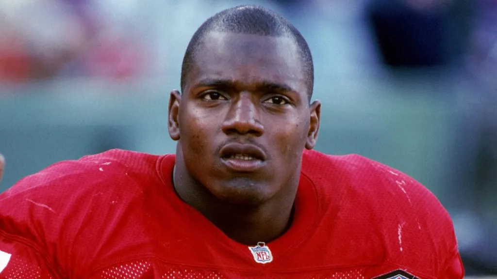 Bryant Young #97 of the San Francisco 49ers sits on the bench during a preseason game in 1994. (Source: George Rose/Getty Images)