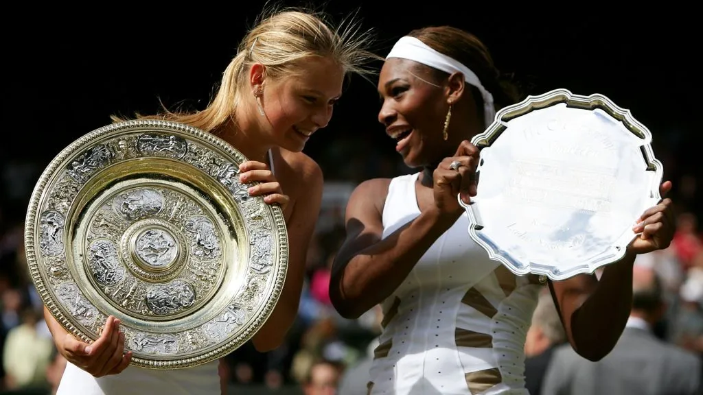 Maria Sharapova poses with her trophy after she won against Serena Williams at the 2004 Wimbledon final. (Mike Hewitt/Getty Images)