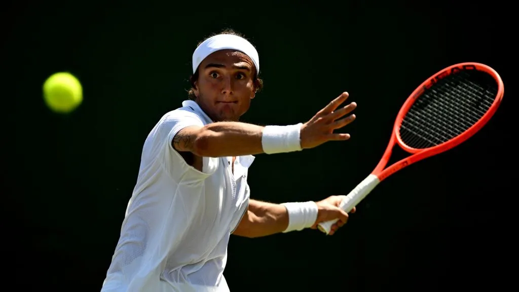 Mattia Bellucci plays a forehand against Oliver Crawford during the Gentlemen’s Singles first round match on day one of The Championships Wimbledon 2025. (Source: Mike Hewitt/Getty Images)