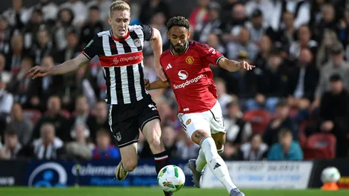 Matheus Cunha of Manchester United is challenged by Harvey Rodgers of Grimsby Town during the Carabao Cup.
