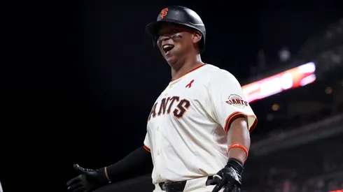 Rafael Devers #16 of the San Francisco Giants reacts after he hit a three-run home run.