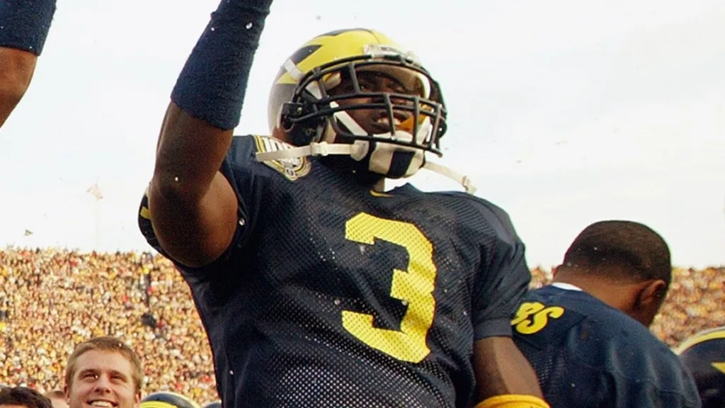 Marlin Jackson celebrates on the sideline during the game against the Ohio State Buckeyes in 2003. (Source: Danny Moloshok/Getty Images)