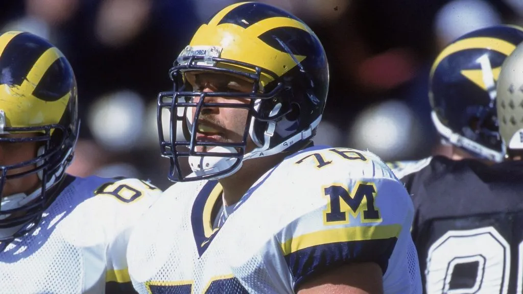 Steve Hutchinson #76 of the Michigan Wolverines walks on the field during the game against the Purdue Boilermakers in 2000. (Source: Jonathan Daniel /Allsport)
