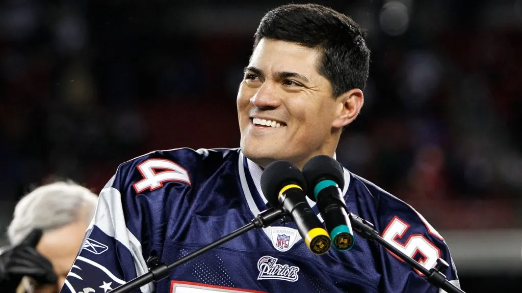 Tedy Bruschi speaks at the pdium during a halftime ceremony honoring his playing career as the Patriots host the New York Jets in 2010. (Source: Jim Rogash/Getty Images)