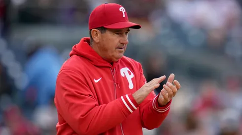 Rob Thomson claps as he walks to the pitcher's mound on April 06, 2024 in Washington, DC.