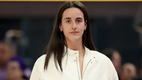 Injured Caitlin Clark #22 of the Indiana Fever stands on the side of the court.