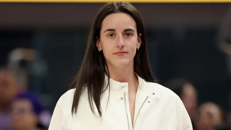Injured Caitlin Clark #22 of the Indiana Fever stands on the side of the court.