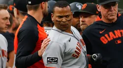 Rafael Devers #16 and Manager Bob Melvin of the San Francisco Giants stand on the field.
