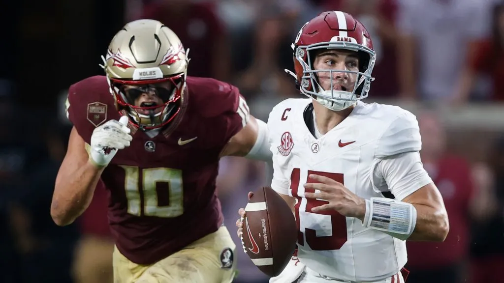 Ty Simpson scrambles away from pressure from James Williams