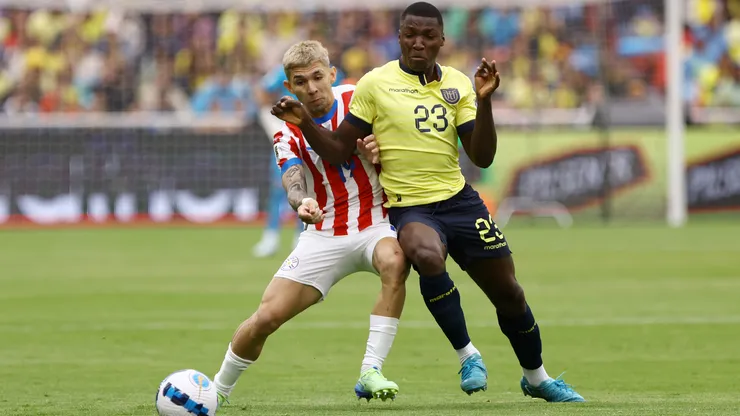 ulio Enciso of Paraguay and Moises Caicedo of Ecuador battle for the ball.
