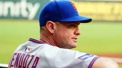 Carlos Mendoza #64 of the New York Mets looks on from the dugout against the Atlanta Braves.