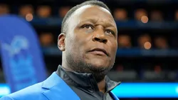 Former player Barry Sanders looks on.