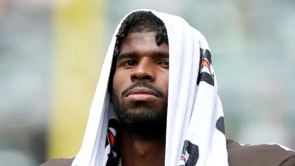 Shedeur Sanders watching from the sideline.