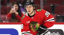 Connor Bedard #98 of the Chicago Blackhawks controls the puck.