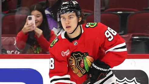 Connor Bedard #98 of the Chicago Blackhawks controls the puck.