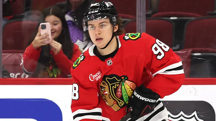 Connor Bedard #98 of the Chicago Blackhawks controls the puck.
