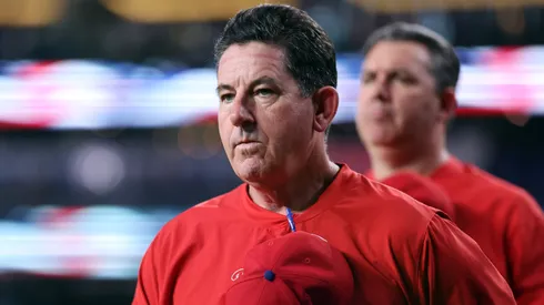 Rob Thomson of the Phillies stands on the field for the National Anthem.