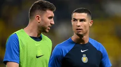 Cristiano Ronaldo speaks with Aymeric Laporte of Al Nassr FC during a warm up.