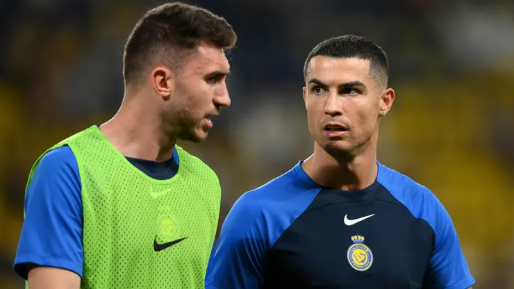 Cristiano Ronaldo speaks with Aymeric Laporte of Al Nassr FC during a warm up.