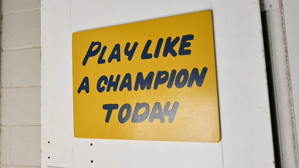 A sign with “Play Like A Champion Today” painted on it is display outside of the Notre Dame locker room. (Source: Sam Wasson/Getty Images)