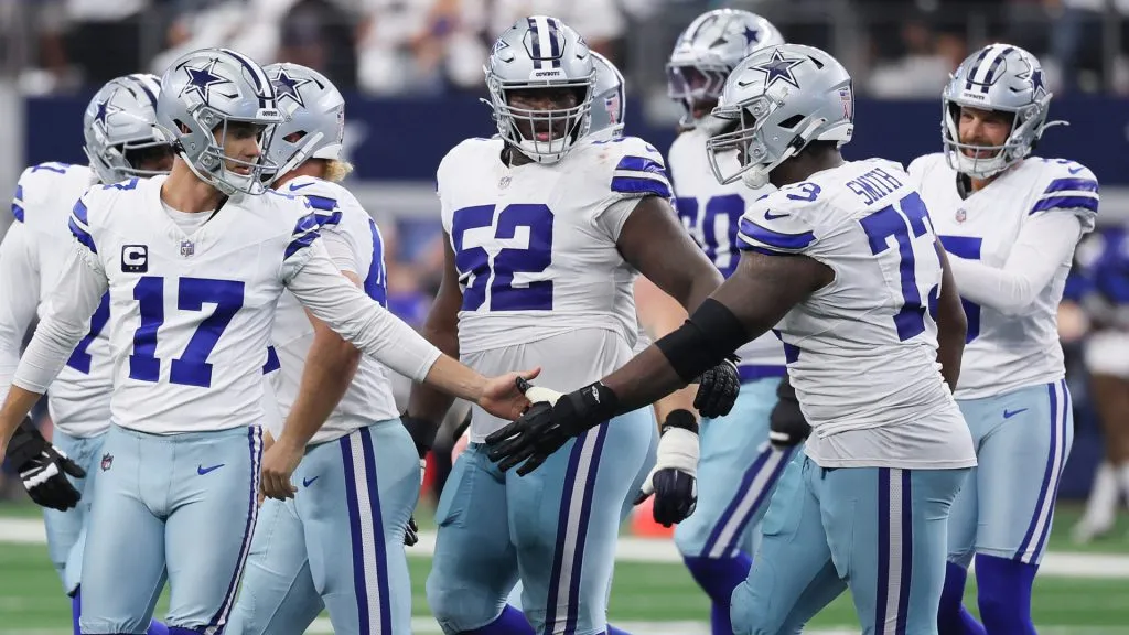 Dallas Cowboys players talking amid a game