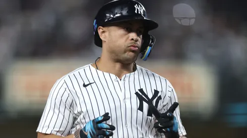 Giancarlo Stanton #27 of the New York Yankees reacts after hitting a home run.