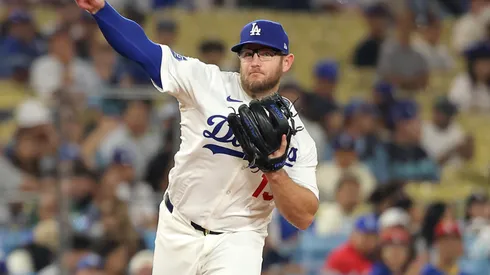 Max Muncy #13 of the Los Angeles Dodgers throws to first base.