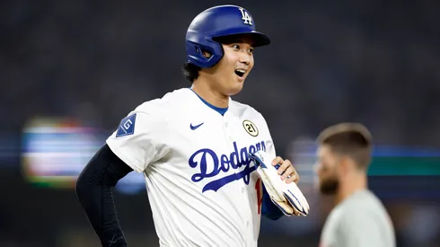 Shohei Ohtani #17 of the Los Angeles Dodgers walks to first base.