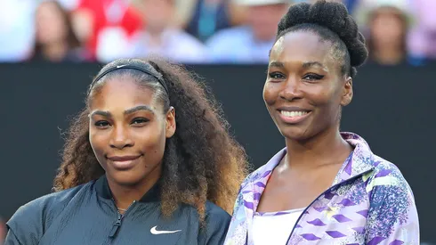 Venus Williams and Serena Williams pose for a photo prior to a game.