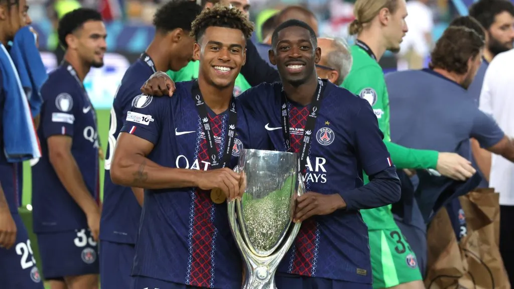 Desire Doue and Ousmane Dembele of Paris Saint-Germain with the UEFA Super Cup trophy. (Claudio Villa/Getty Images)