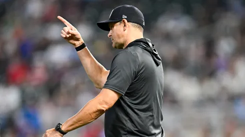 Manager Aaron Boone #17 of the New York Yankees calls to the bullpen.