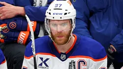 Connor McDavid (#97) looks on from the Oilers bench during NHL action.