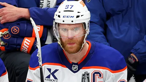 Connor McDavid (#97) looks on from the Oilers bench during NHL action.