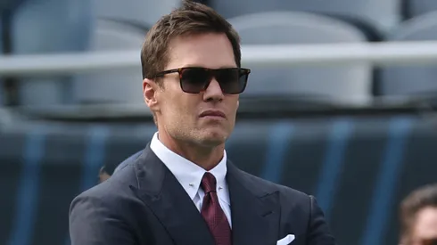 Tom Brady looks on from the sidelines.