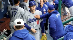 Los Angeles Dodgers manager Dave Roberts taps Roki Sasaki #11 on the chest.
