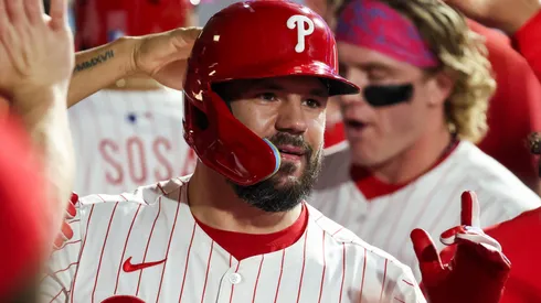 Kyle Schwarber #12 of the Philadelphia Phillies reacts in the dugout after hitting a home run.