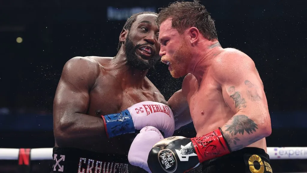 Terence Crawford exchanges punches with Canelo Alvarez in their&nbsp;undisputed super middleweight title fight. (Photo by Sarah Stier/Getty Images for Netflix)