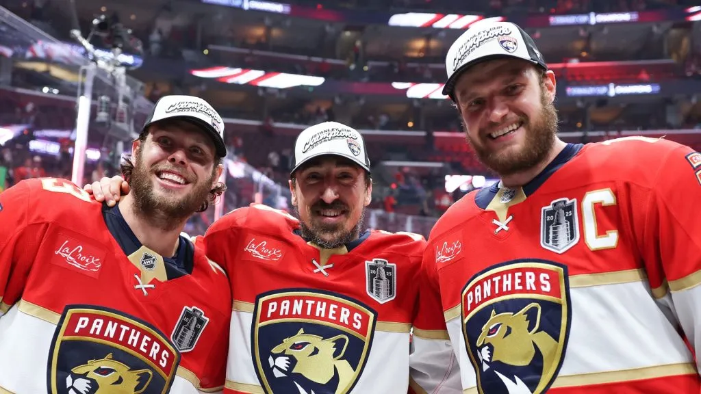 From left to right: Carter Verhaeghe, Brad Marchand, and Aleksander Barkov hug