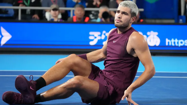 Carlos Alcaraz lays on the floor during the Japan Open.