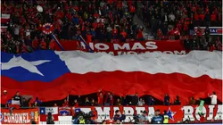 Fans of Chile display a large flag